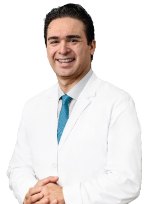 VTC_DrEtaee_Headshot_-1_optimized Professional portrait of Dr. Walter Lech, a vein specialist, wearing a white lab coat and glasses, posed against a black background with arms crossed. This formal clinical headshot represents a healthcare provider specializing in vein treatment services.