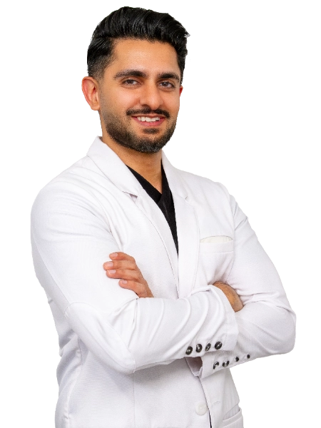 VTC_DrMehta_Coat_1_2745x3660_optimized Professional headshot of Dr. Akash Mehta posed with arms crossed against a black background, wearing a white blazer and black shirt. This formal studio portrait is suitable for medical practice marketing and professional representation.